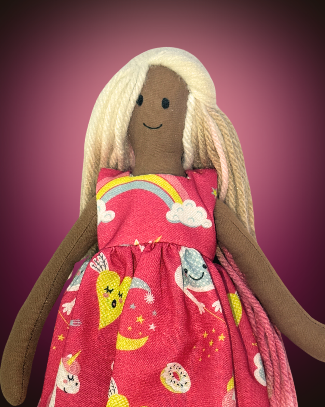 Soft organic cotton doll (UNINA ESPRESSO BLUSHIE) in a pink rainbow dress – non-toxic toy for infants