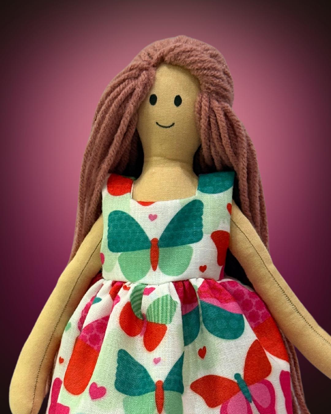 Soft organic doll (NINA HONEY PINKISH BROWN) with green butterfly dress – sustainable and biodegradable toy