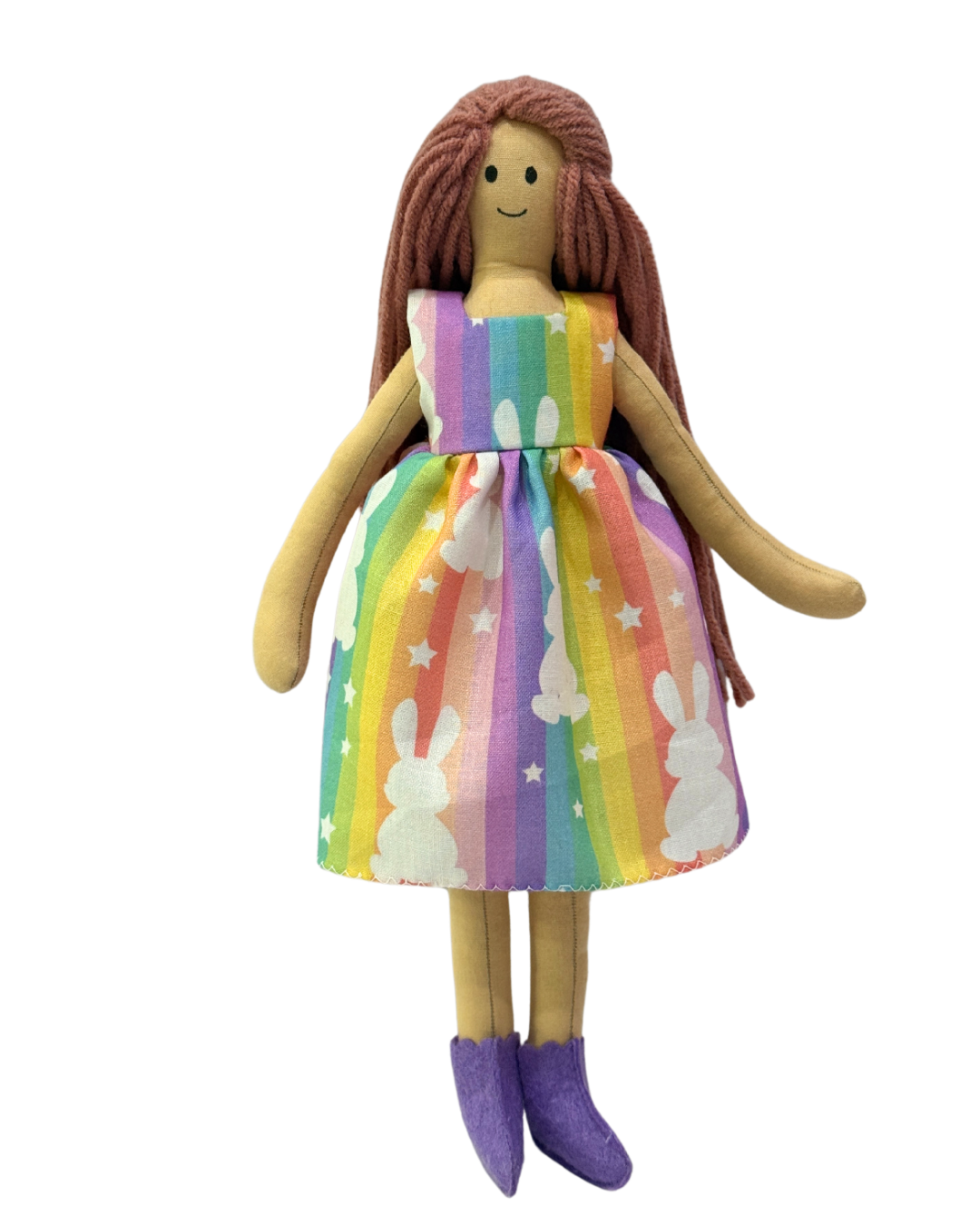 Sustainable baby doll (NINA HONEY PINKISH BROWN) in playful rainbow bunny outfit – organic cotton and non-toxic materials