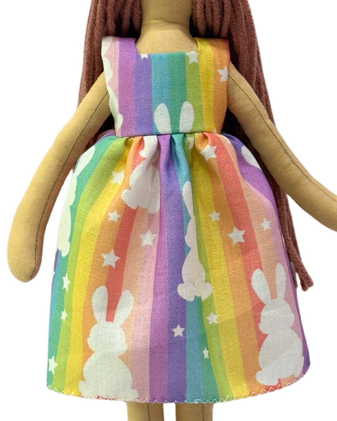 Sustainable baby doll (NINA HONEY PINKISH BROWN) in playful rainbow bunny outfit – organic cotton and non-toxic materials