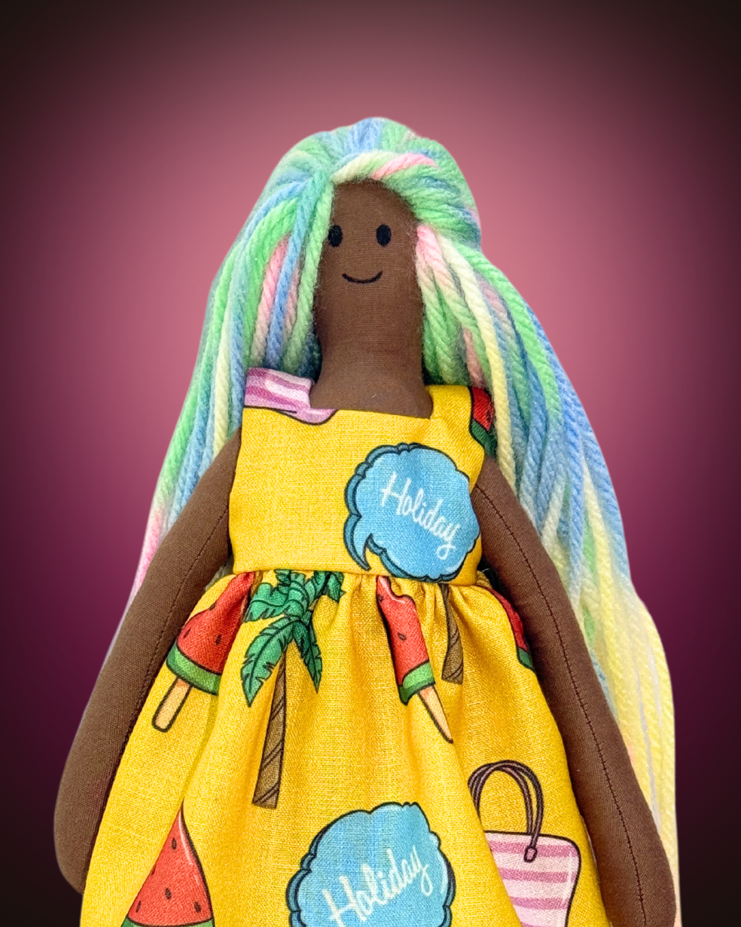 Cheerful handmade doll (UNINA ESPRESSO RAINBOW) wearing a bright yellow holiday dress, a safe and sustainable gift
