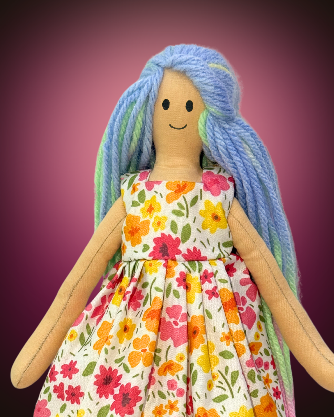 Soft eco-friendly doll with turquoise yarn hair and a floral summer dress, designed as a sustainable toy for baby girls